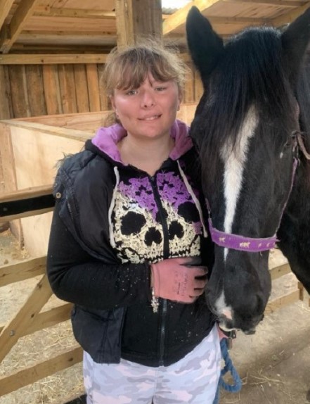 Photo of Charlotte with a horse