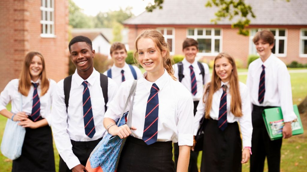 Senior school children in uniform outside of school